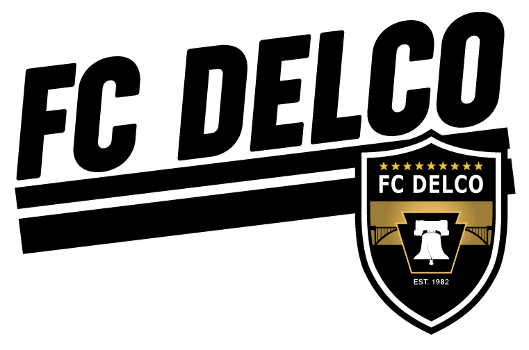 FC DELCO logo featuring bold black text and a crest with nine stars, the Liberty Bell inside a keystone, and the text "EST. 1982."