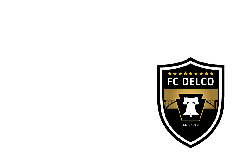 Black and gold shield logo for FC DELCO featuring nine stars, a Liberty Bell icon inside a keystone, and "EST. 1982".