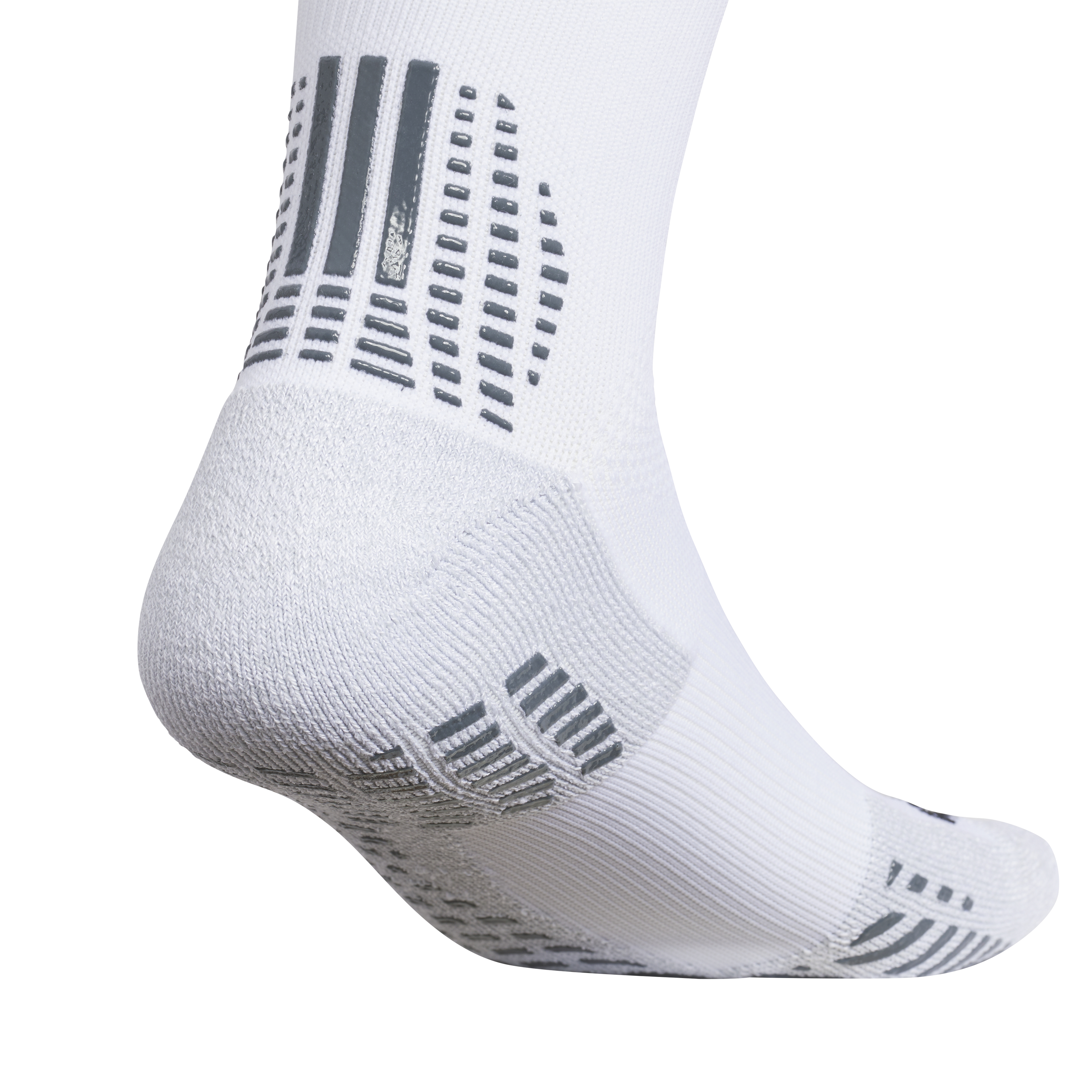 Close-up of a white performance sock with grey rubberized grip patterns on the heel and sole for traction.