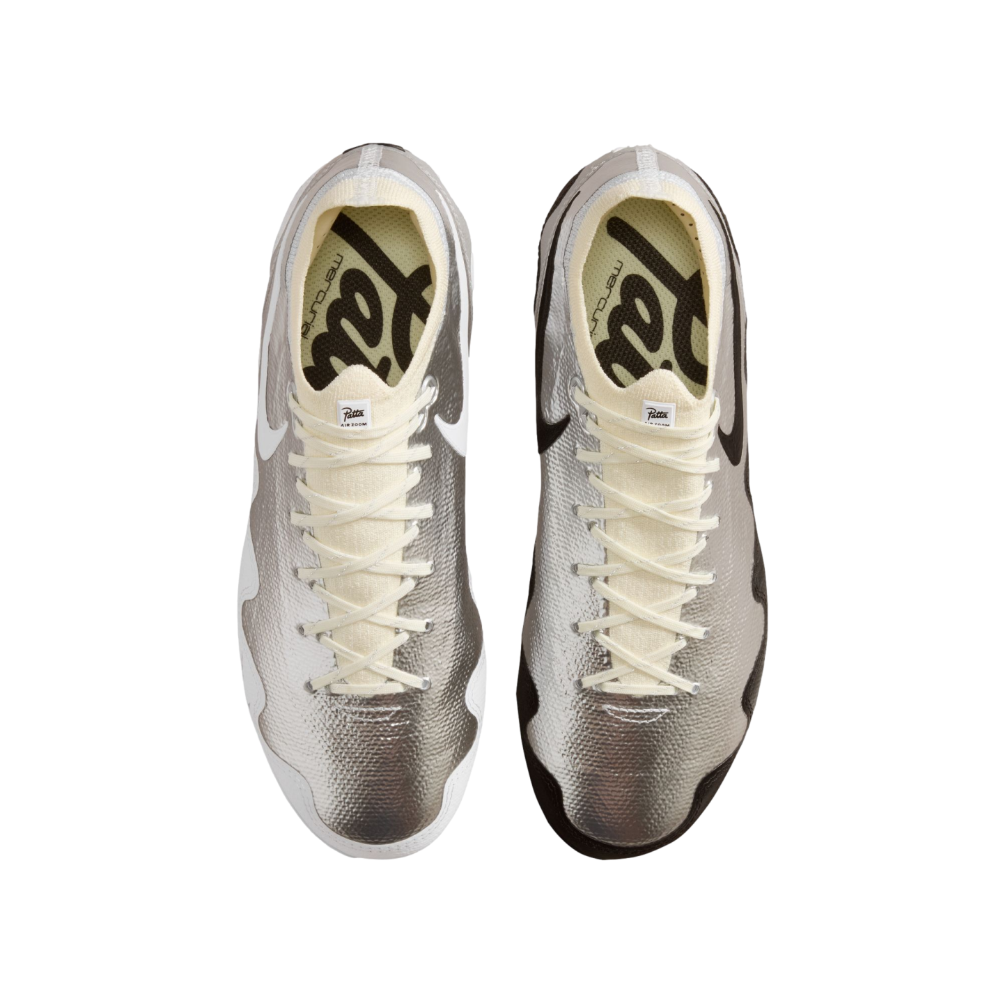 A bird’s-eye view of a pair of metallic silver Nike Mercurial soccer cleats against a solid black background. The left shoe has white swooshes and trim, while the right shoe has black swooshes and trim. Both shoes feature cream-colored laces and knit ankle collars, and yellow insoles with black Patta branding.