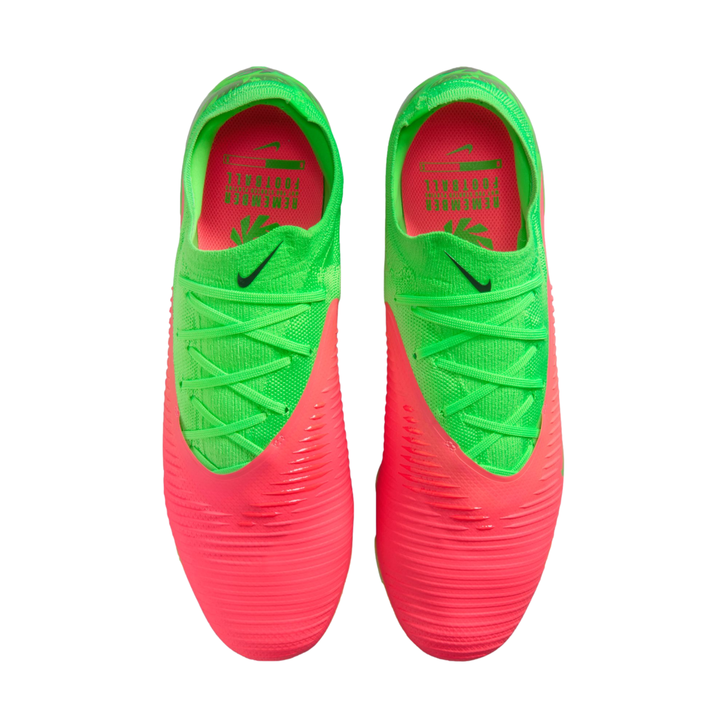 A top-down view of a pair of neon green and bright pink Nike soccer cleats against a solid black background. The front of the boots is pink with horizontal ridges, transitioning to a neon green upper with matching green laces and a small black Nike swoosh.