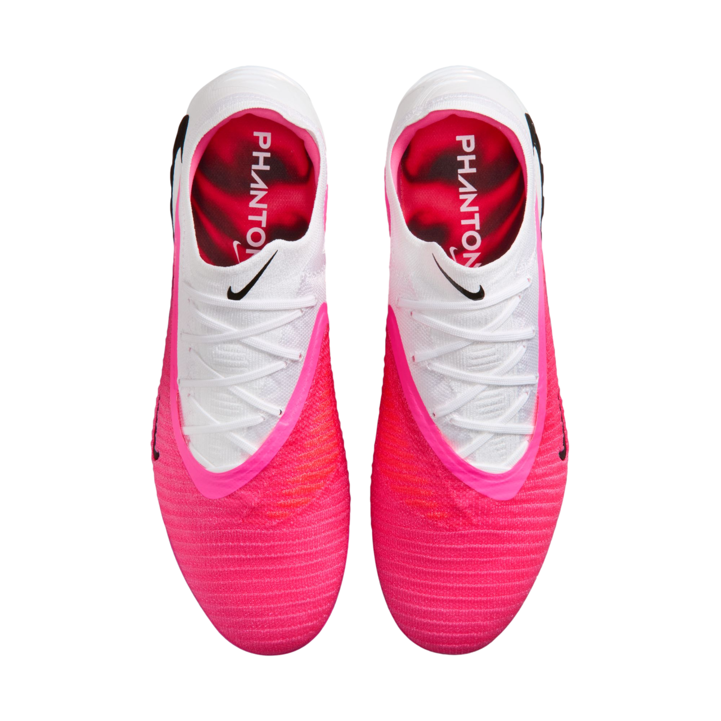 Top-down view of bright pink and white Nike Phantom soccer cleats.