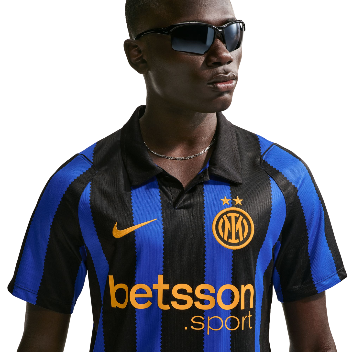A man wearing an Inter Milan blue and black striped football jersey and dark sunglasses against a white background.