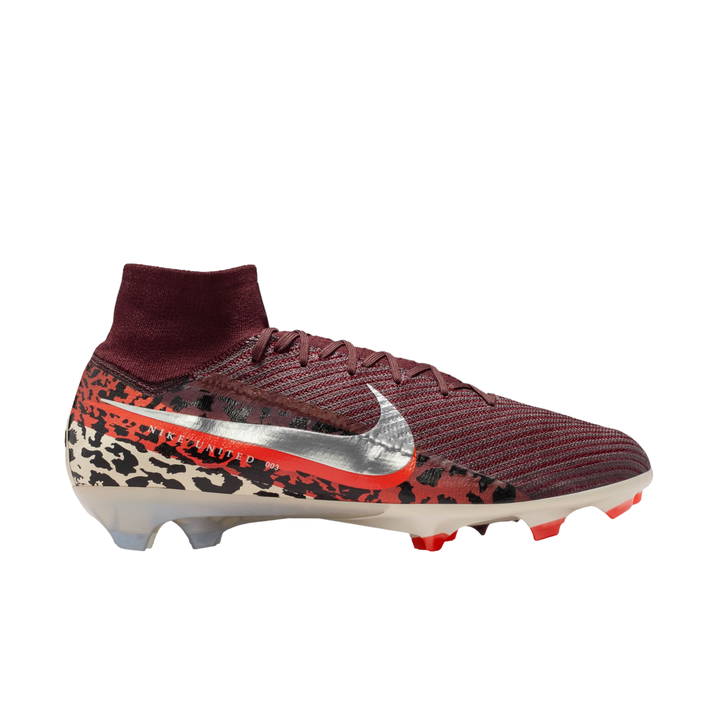 A high-top Nike soccer cleat is shown from a side profile against a solid black background. The shoe features a burgundy ribbed upper and a matching sock-like ankle collar. A large, metallic silver Nike swoosh with an orange border sits on the side, printed with the text "NIKE UNITED 003." The heel and base are detailed with a bold, multi-colored animal print in black, orange, and cream. The soleplate is translucent white with vibrant red studs.