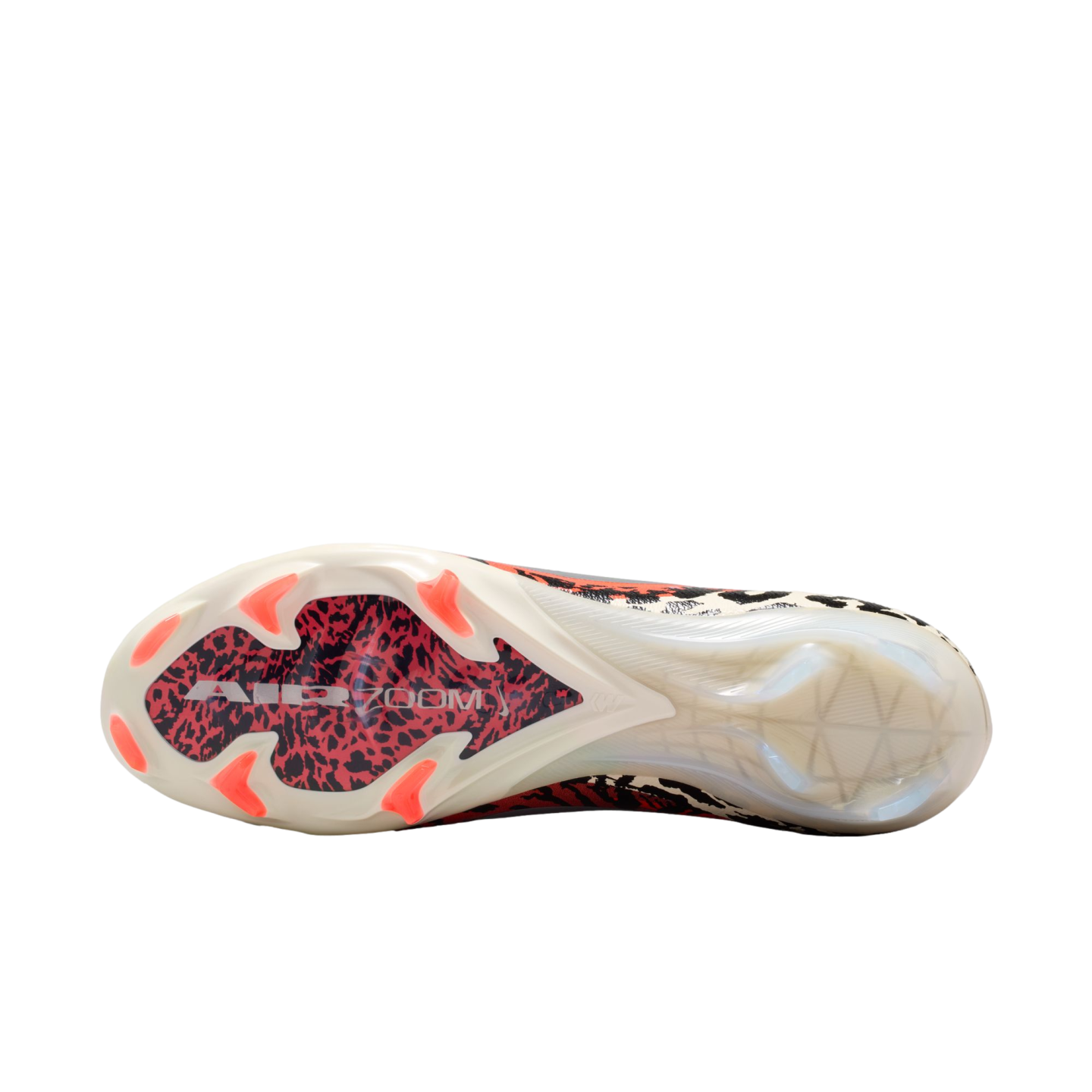 A close-up, bottom view of a soccer cleat's outsole against a solid black background. The cream-colored sole features six bright red-orange studs in the forefoot and a central red and black leopard-print pattern with white "AIR ZOOM" text. The heel section is made of translucent white plastic.