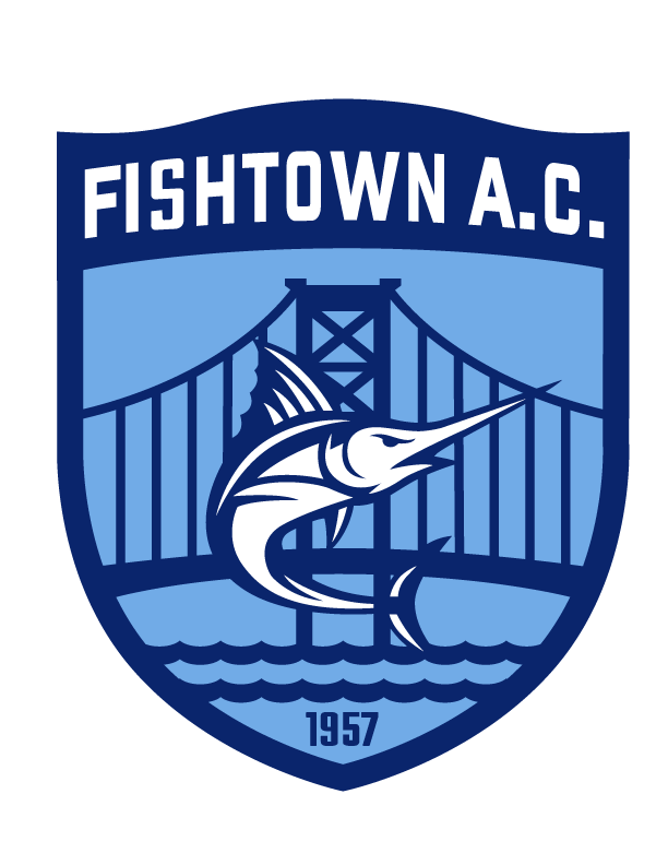 A shield-shaped logo for Fishtown A.C. in shades of blue and white. It features a stylized white marlin jumping in front of a suspension bridge and waves, with the text "FISHTOWN A.C." at the top and the year "1957" at the bottom.