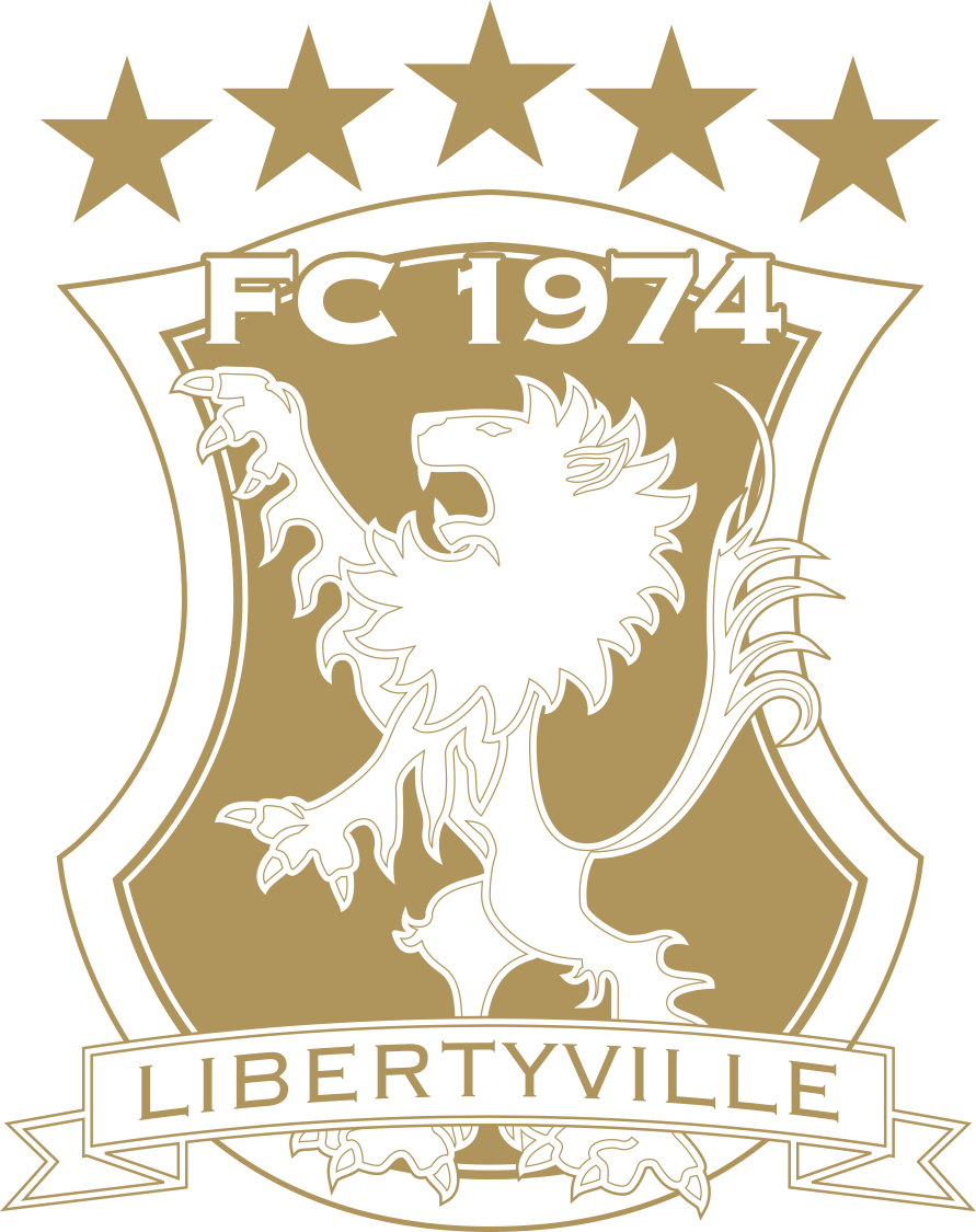 Gold and white logo for Libertyville FC 1974 featuring a shield with a heraldic lion, five stars above, and a banner at the bottom with the club name.