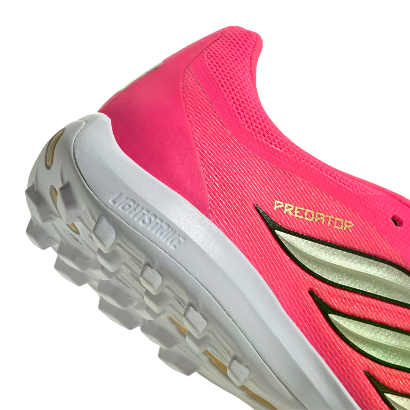 Close-up of a pink Adidas Predator shoe heel with a white Lightstrike midsole and textured outsole.