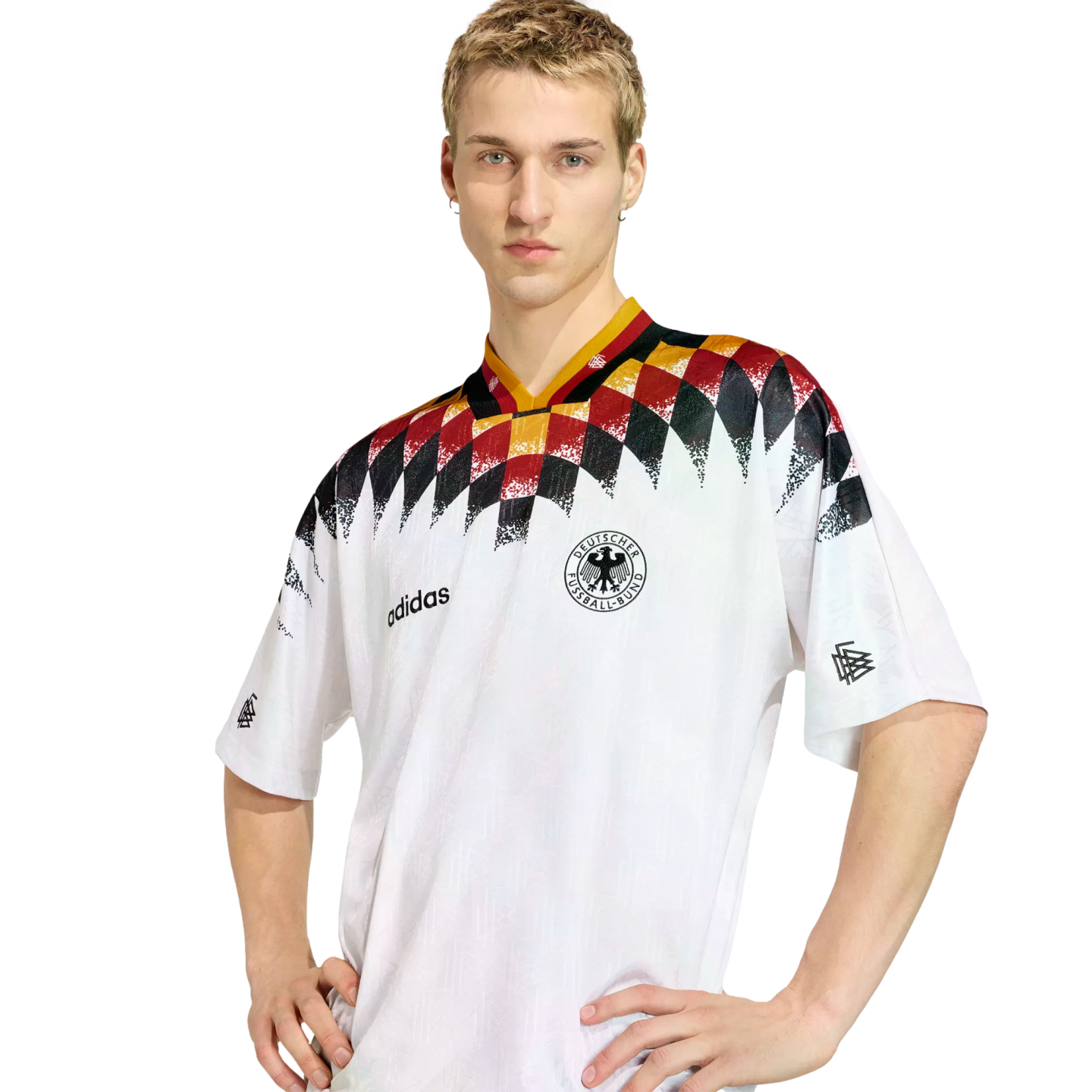 A man wearing a white Adidas Germany national football team jersey with a black, red, and yellow diamond graphic across the chest and shoulders.