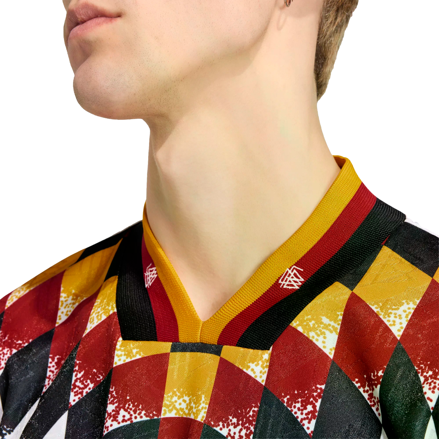 Close-up of a person's neck and jawline wearing a V-neck jersey with a colorful diamond pattern in red, yellow, black, and green. The collar features yellow, red, and black stripes.