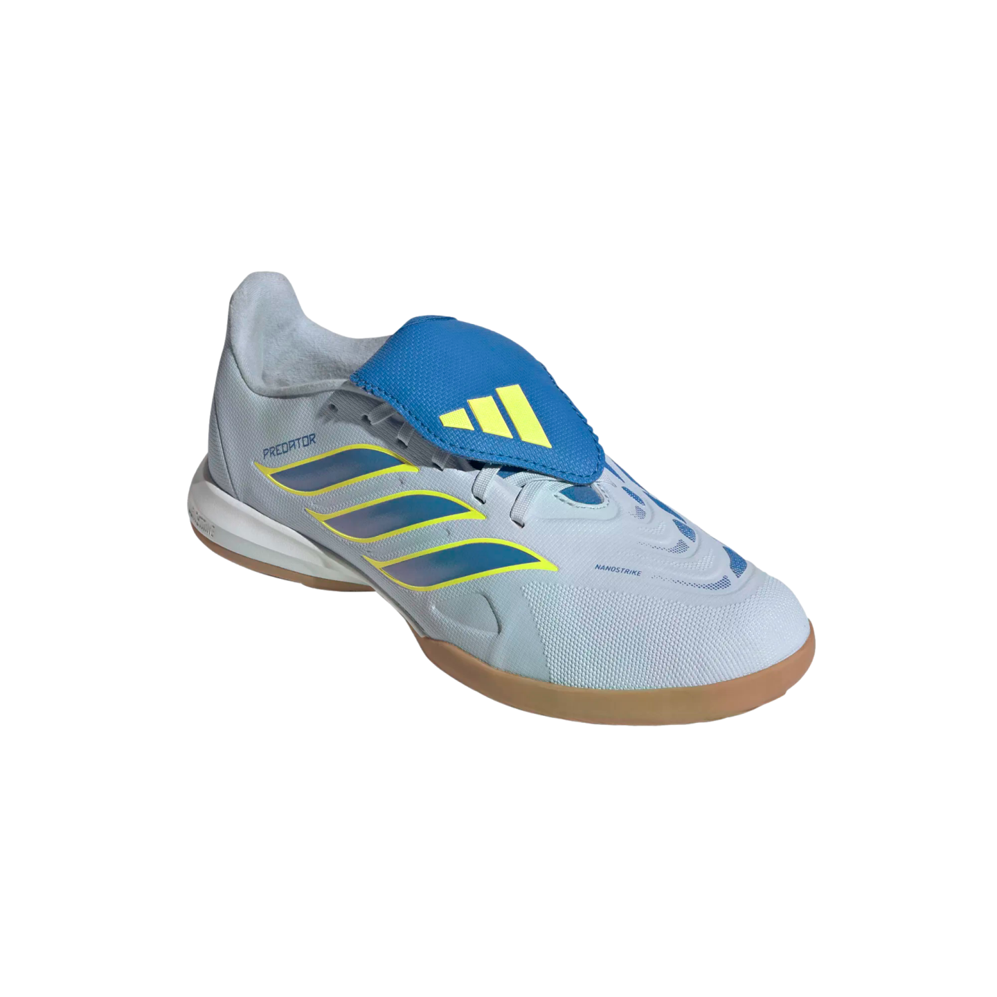 A side-angle view of an Adidas Predator indoor soccer shoe against a black background. The shoe features a light grey textured upper with three iridescent blue stripes outlined in yellow, a prominent blue fold-over tongue with a yellow Adidas logo, and a classic tan gum rubber outsole.