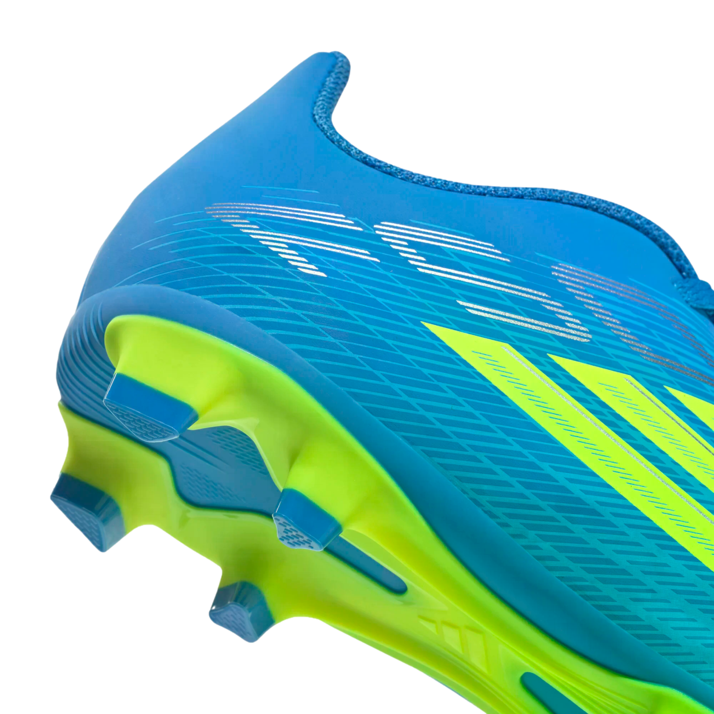 A close-up, side-angle view of the heel and sole of a bright blue soccer cleat against a black background. The shoe features lime green accents, including three diagonal stripes and a vibrant green soleplate with blue triangular studs. Silver graphic lines are visible on the blue upper.