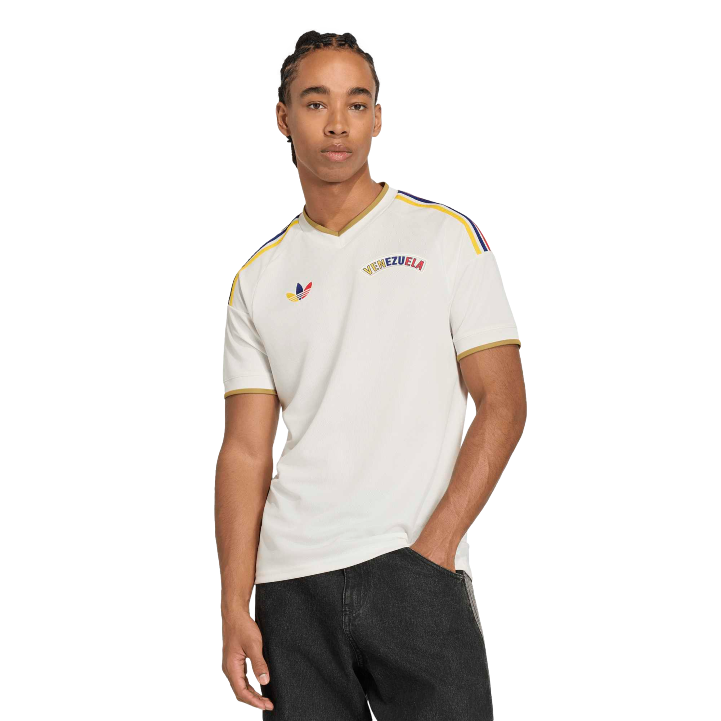A man in a white Adidas Venezuela jersey with colorful shoulder stripes and gold trim, posed against a black background.
