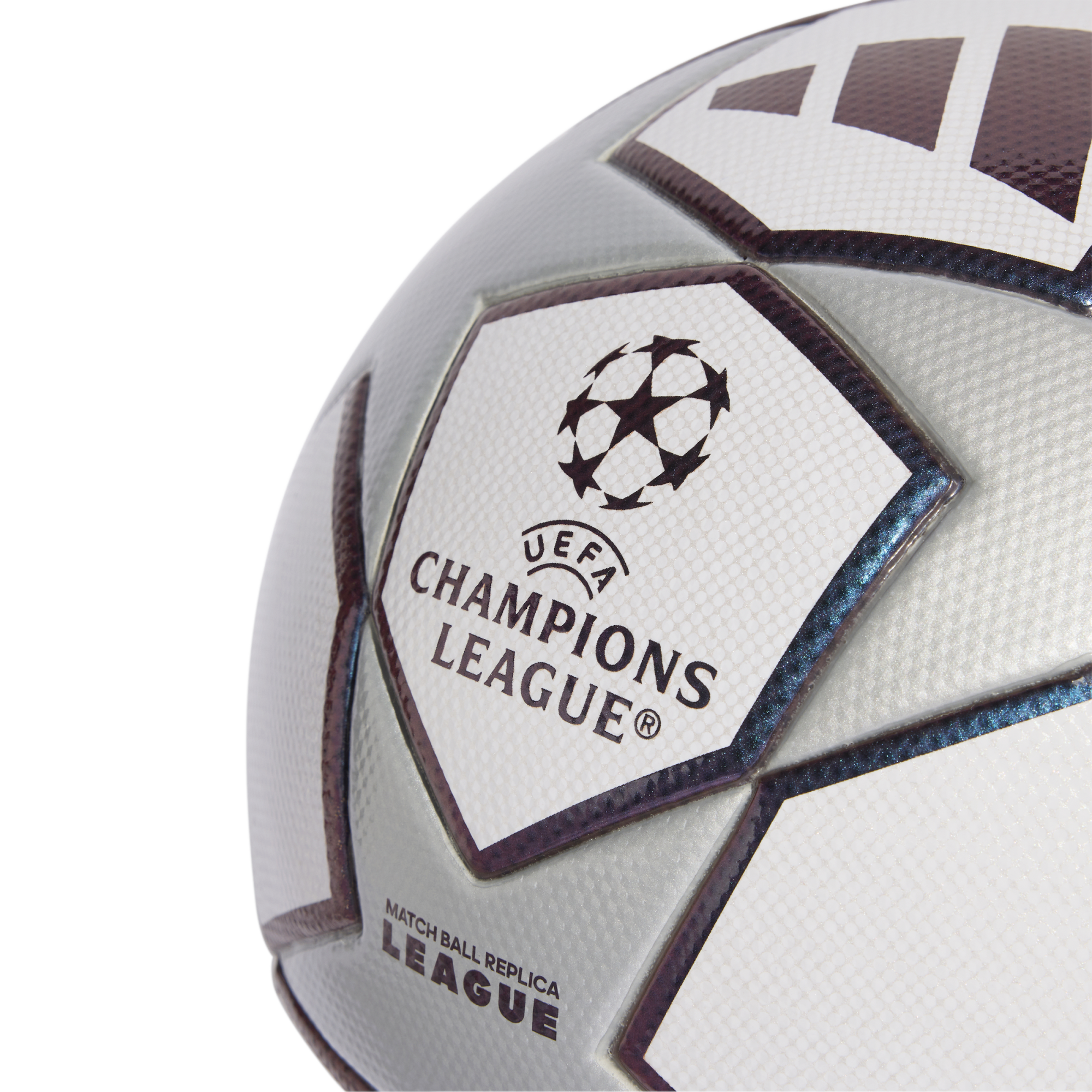 Close-up of a silver and white UEFA Champions League replica soccer ball featuring the official starball logo and textured panels.