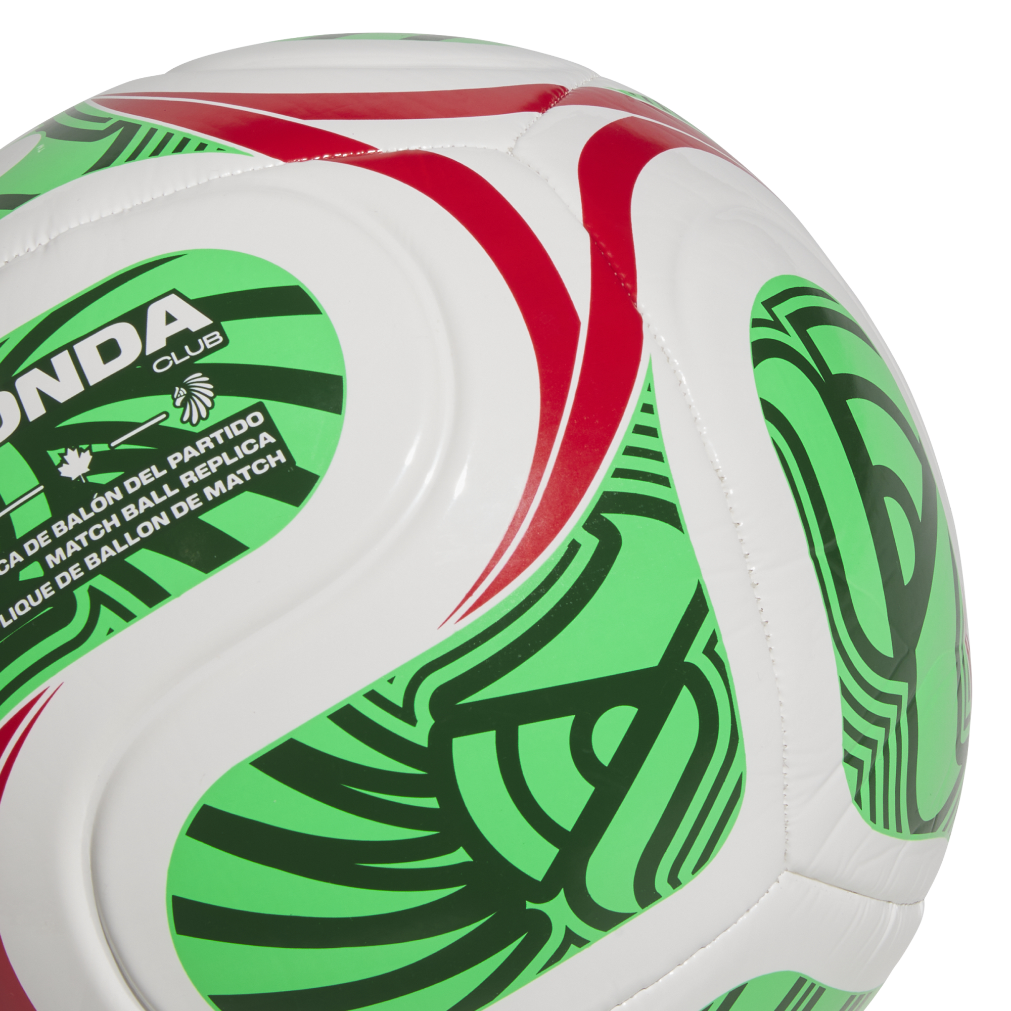 Close-up of a white soccer ball with green and red patterns, featuring "MATCH BALL REPLICA" text and an indigenous-style logo.