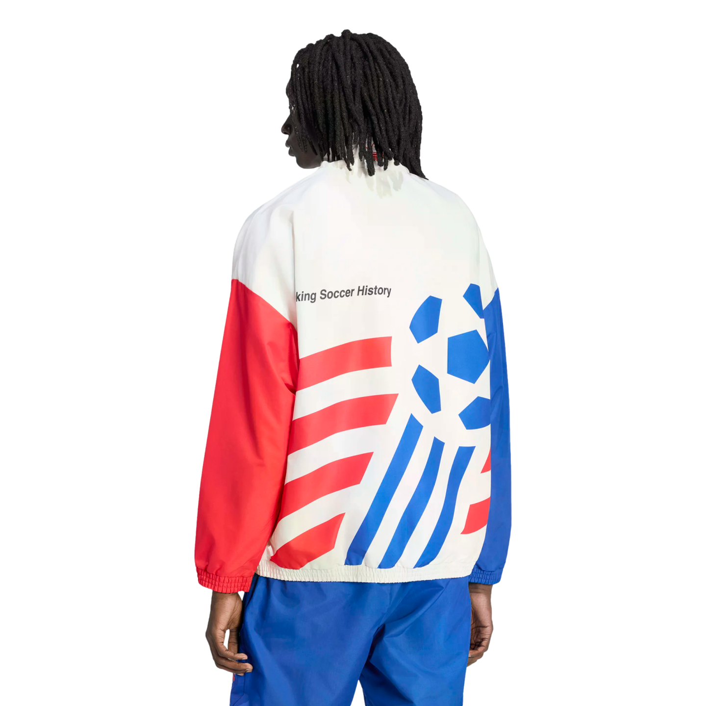Back view of a person with dreadlocks wearing a white, red, and blue track jacket and blue pants against a black background. The jacket features bold red diagonal stripes on one side, a blue stylized soccer ball graphic on the other, and the text "king Soccer History" across the upper back.