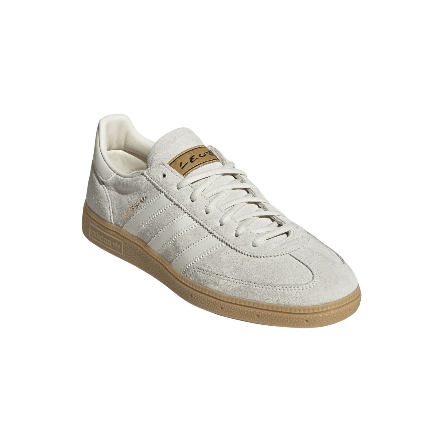 Adidas Samba Messi sneaker featuring an off-white suede upper, white leather stripes, a gum rubber sole, and gold Messi branding on the side and tongue.