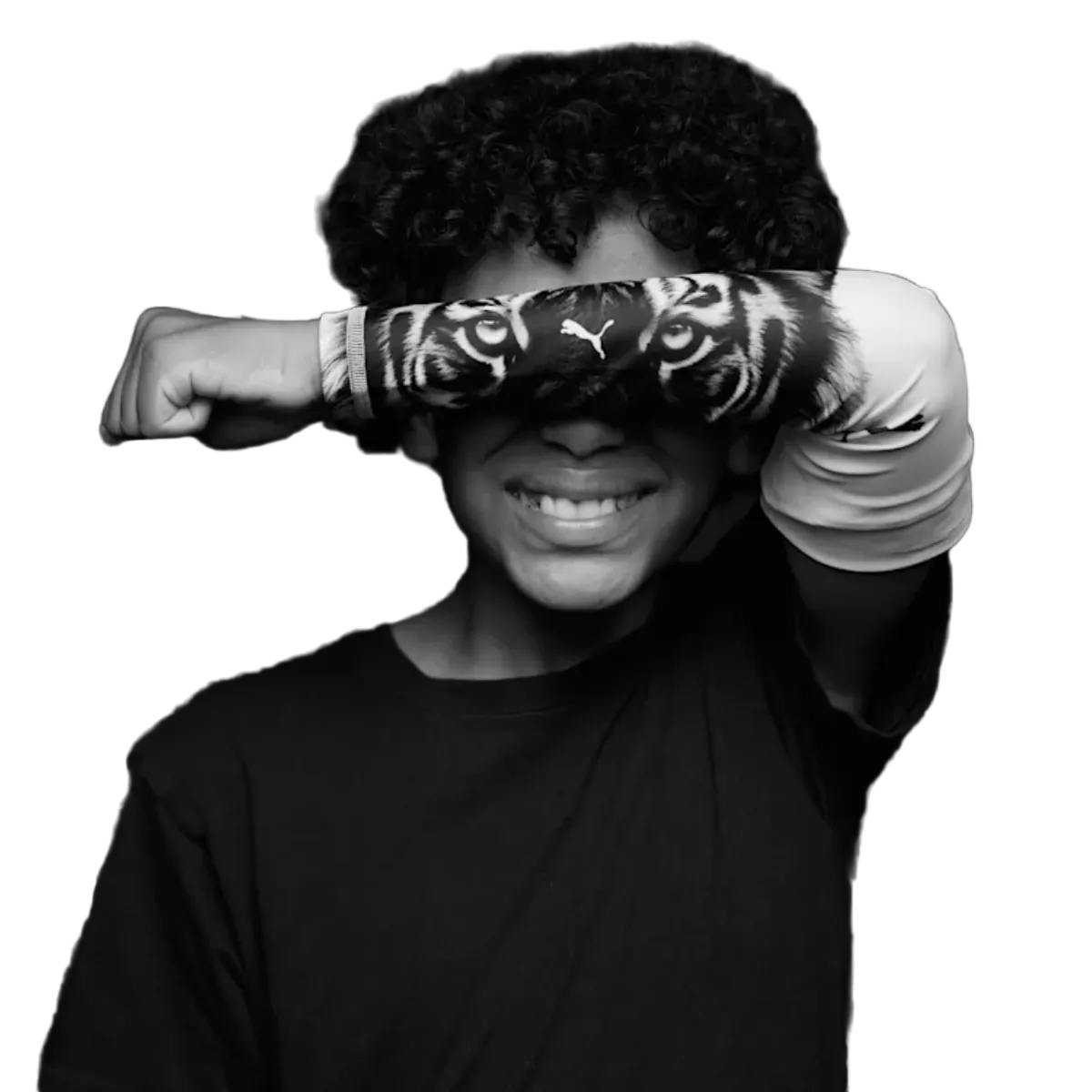 Black and white photo of a smiling person with curly hair holding a tiger-print sleeve over their eyes.