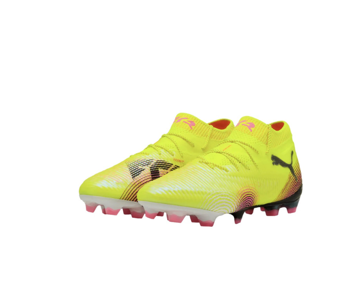 A pair of neon yellow Puma soccer cleats with pink and black patterned accents and high-top collars.