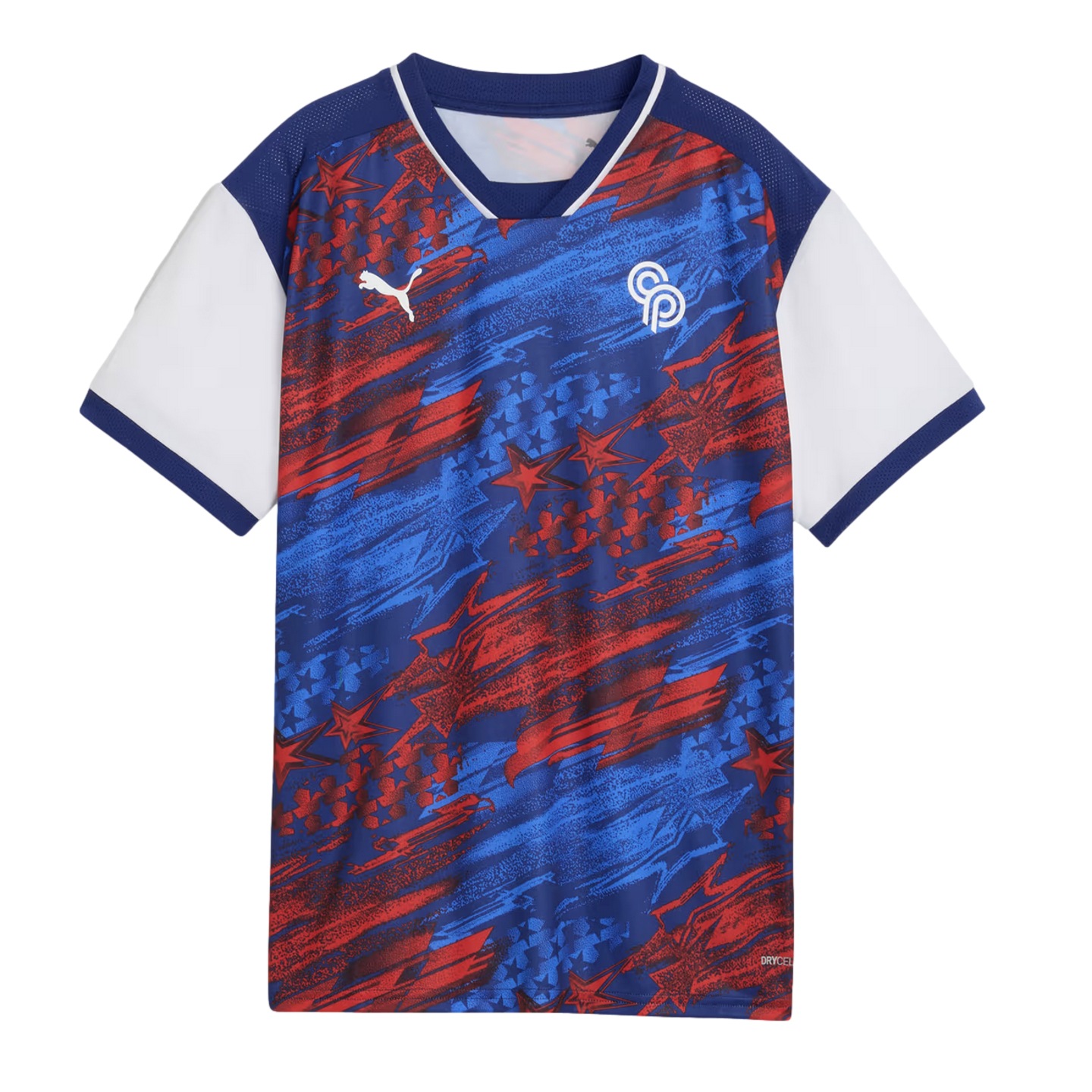 A short-sleeved Puma soccer jersey with a patriotic red, white, and blue theme. The main body of the shirt features an energetic, abstract pattern of blue and red brushstrokes and stars on a navy background. The jersey has a navy blue V-neck collar with white trim, solid white short sleeves with navy cuffs, a white Puma cat logo on the right chest, and a white circular "CP" logo on the left chest.