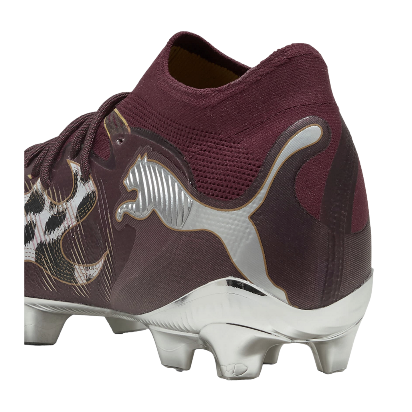 Close-up side view of a maroon Puma soccer cleat featuring a metallic silver logo, chrome-finish soleplate, and a knitted sock-like ankle collar.