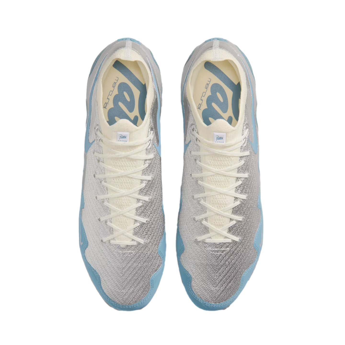 Top-down view of light grey and sky blue soccer cleats with white laces and "Patta" branding on the insoles.