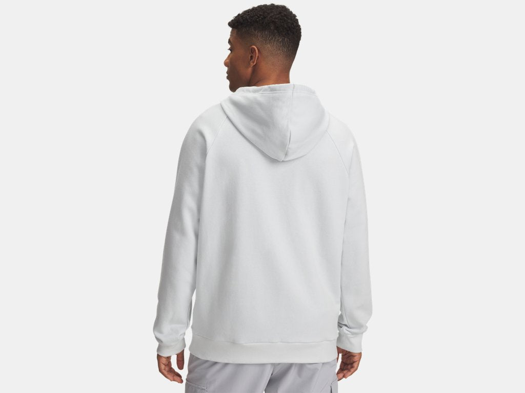 Back view of a man with dark skin wearing a light gray hooded sweatshirt and matching pants, standing against a neutral background.