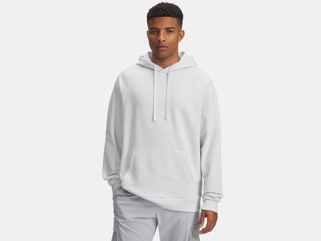 Man in a light gray hoodie and matching cargo pants against a neutral gray background.