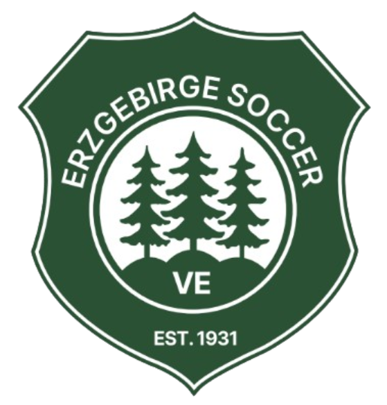 A dark green and white shield-shaped logo for Erzgebirge Soccer. It features three evergreen trees in a central white circle above the letters "VE," with "EST. 1931" at the bottom.