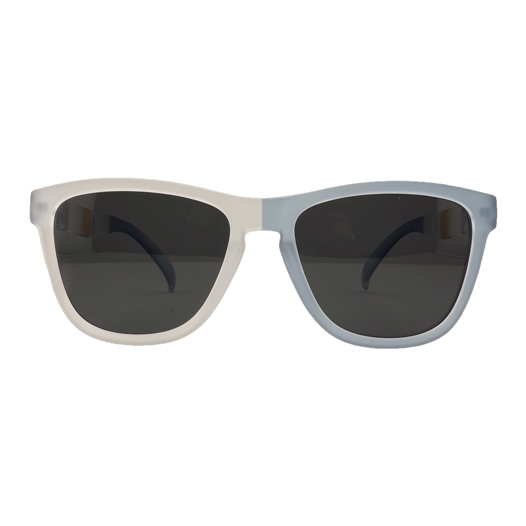 A pair of two-tone sunglasses with a light gray left frame and a muted blue right frame, featuring dark lenses and a classic shape, set against a plain white background.