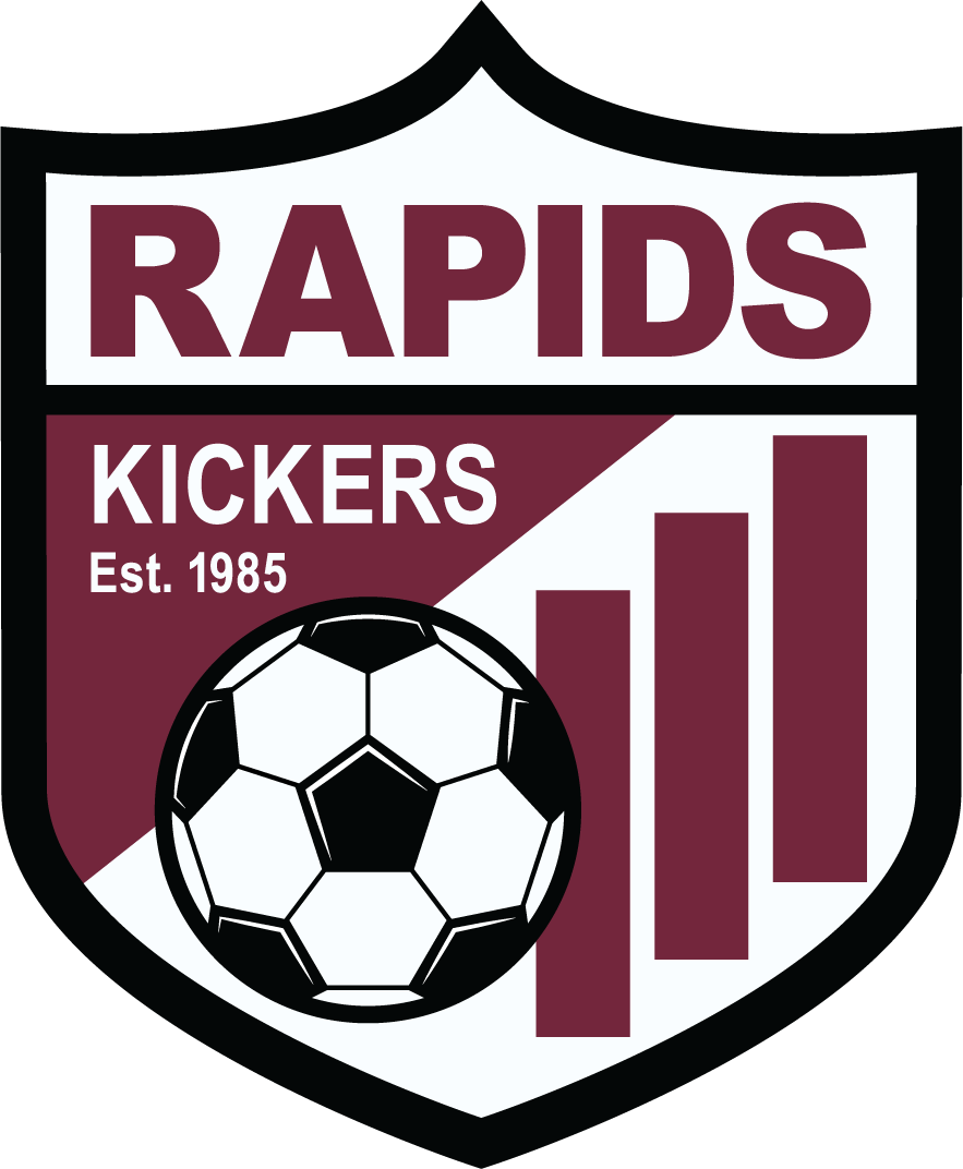 RAPID3 - Rapids Kickers "CREST" POCKET Color: A maroon, white, and black shield-shaped soccer logo. The top features the word "RAPIDS" in large maroon letters on a white background. The middle section is diagonally split with the word "KICKERS" and "Est. 1985" in white on a maroon background at the top left, and three vertical maroon bars on a white background at the bottom right. A black and white soccer ball sits prominently in the foreground.