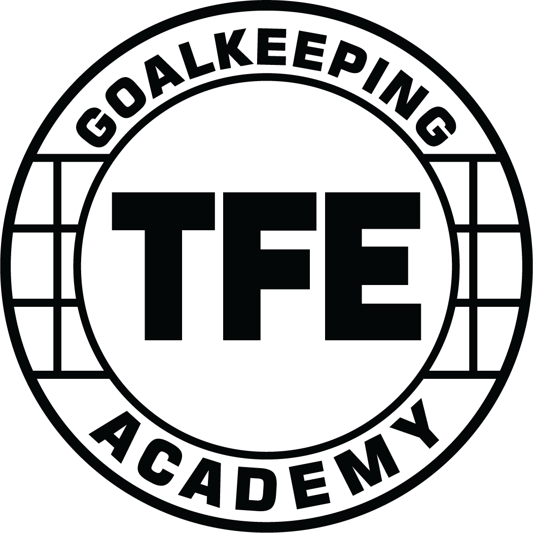 Circular black and white logo for TFE2 - Tonka Fusion Elite "GK ACADEMY" POCKET Black, featuring bold "TFE" text in the center with "GOALKEEPING" and "ACADEMY" curved around the border and a soccer net grid pattern on the sides.