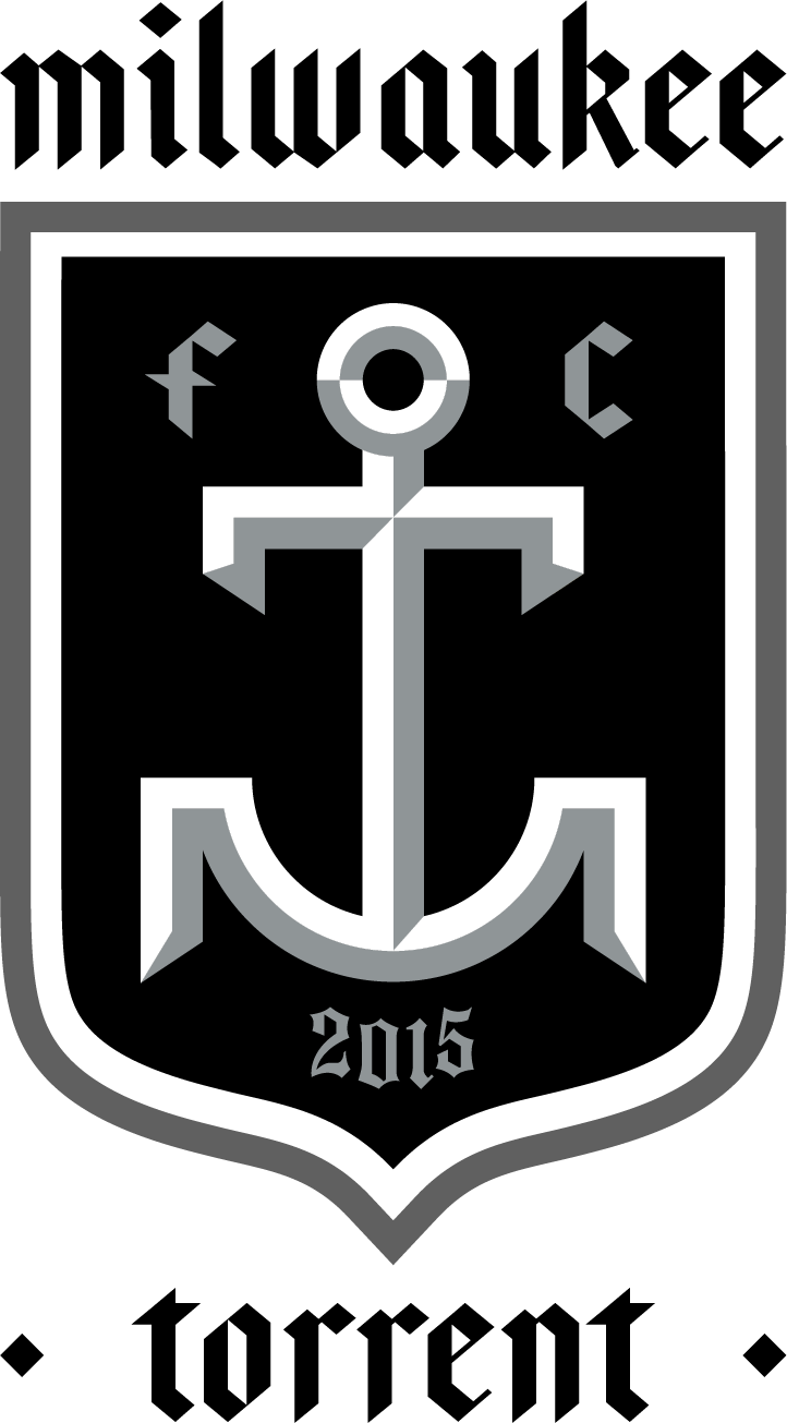 A grayscale graphic for the MKET2 - Milwaukee Torrent "TEXT & CREST" design, featuring gothic-style typography and a central black shield. Inside the shield is a stylized, geometric grey anchor flanked by the letters "f" and "c" at the top and the year "2015" at the bottom.