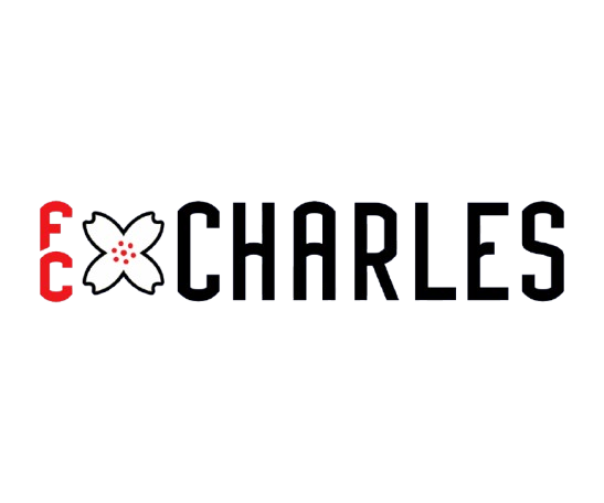 A logo for FCC Black lettering featuring red vertical letters "FC," a white four-petaled flower with red dots, and the word "CHARLES" in black block letters with a thin white outline, all set against a black background.