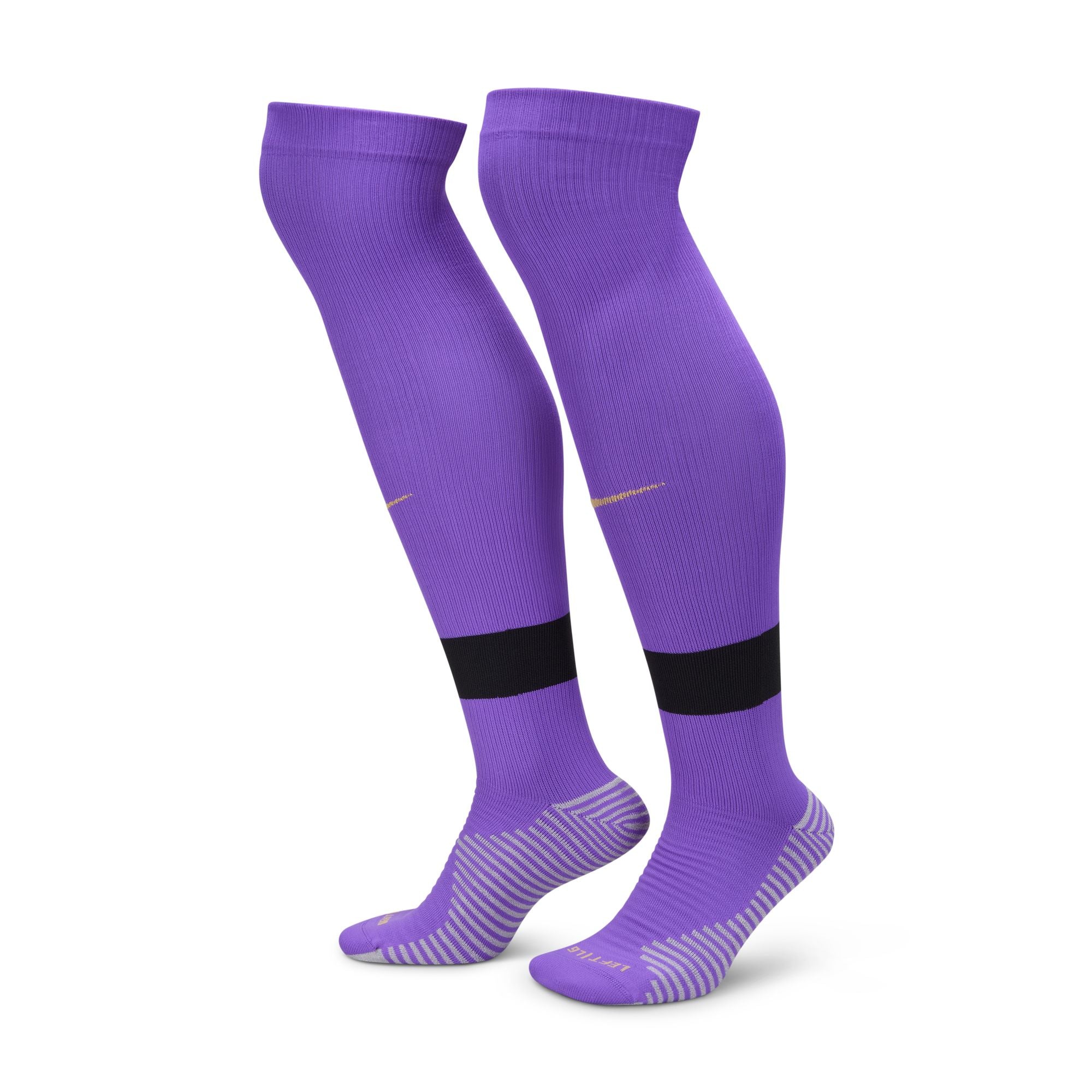 A pair of purple knee-high soccer socks featuring a black horizontal stripe on the calf and grey-striped cushioning on the heel and sole.