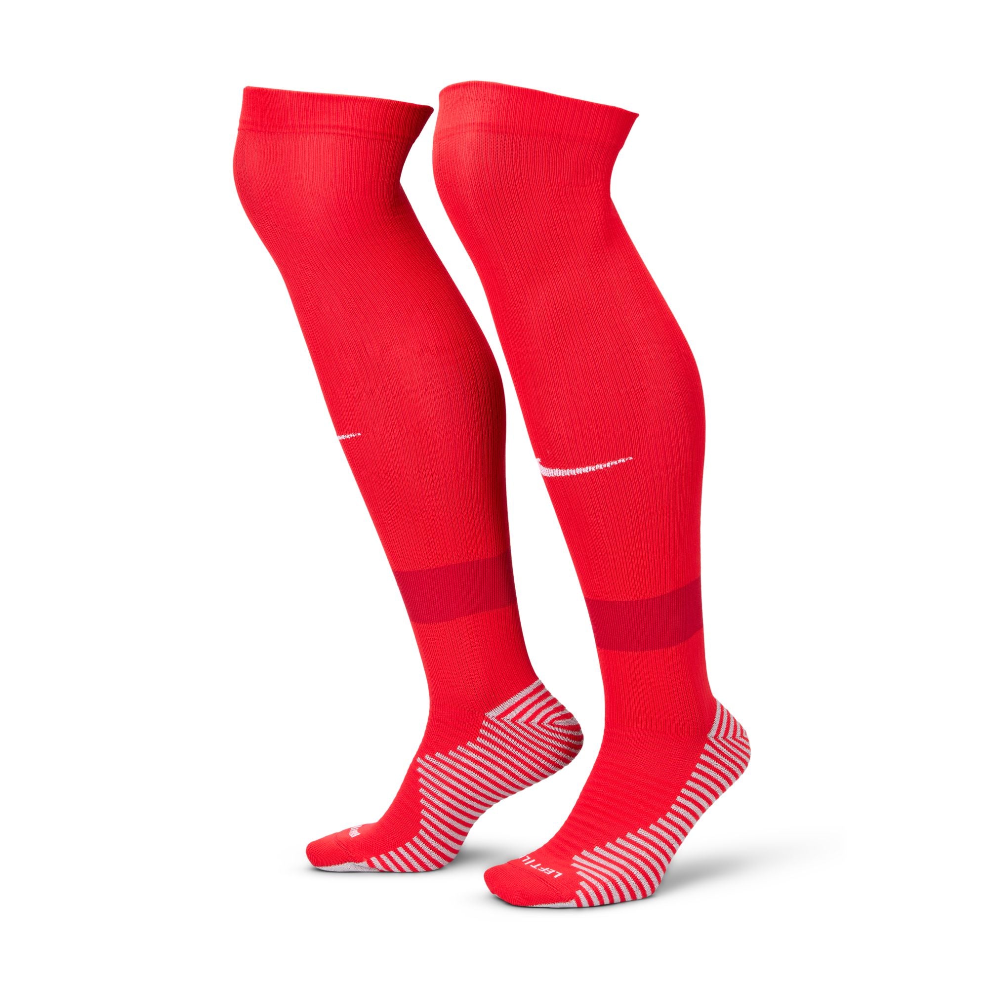 Pair of long red athletic socks with white grip patterns on the feet and a small white logo on the calves.