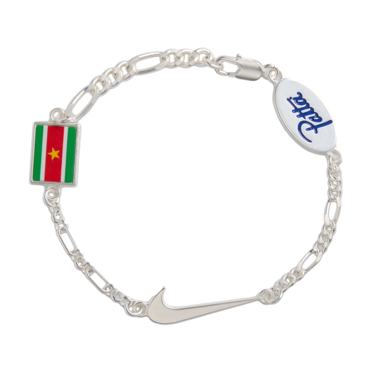 A silver Figaro link bracelet featuring three charms: a rectangular flag of Suriname, a silver Nike swoosh, and an oval tag with the word "Patta" in blue script. The bracelet is shown against a solid black background.