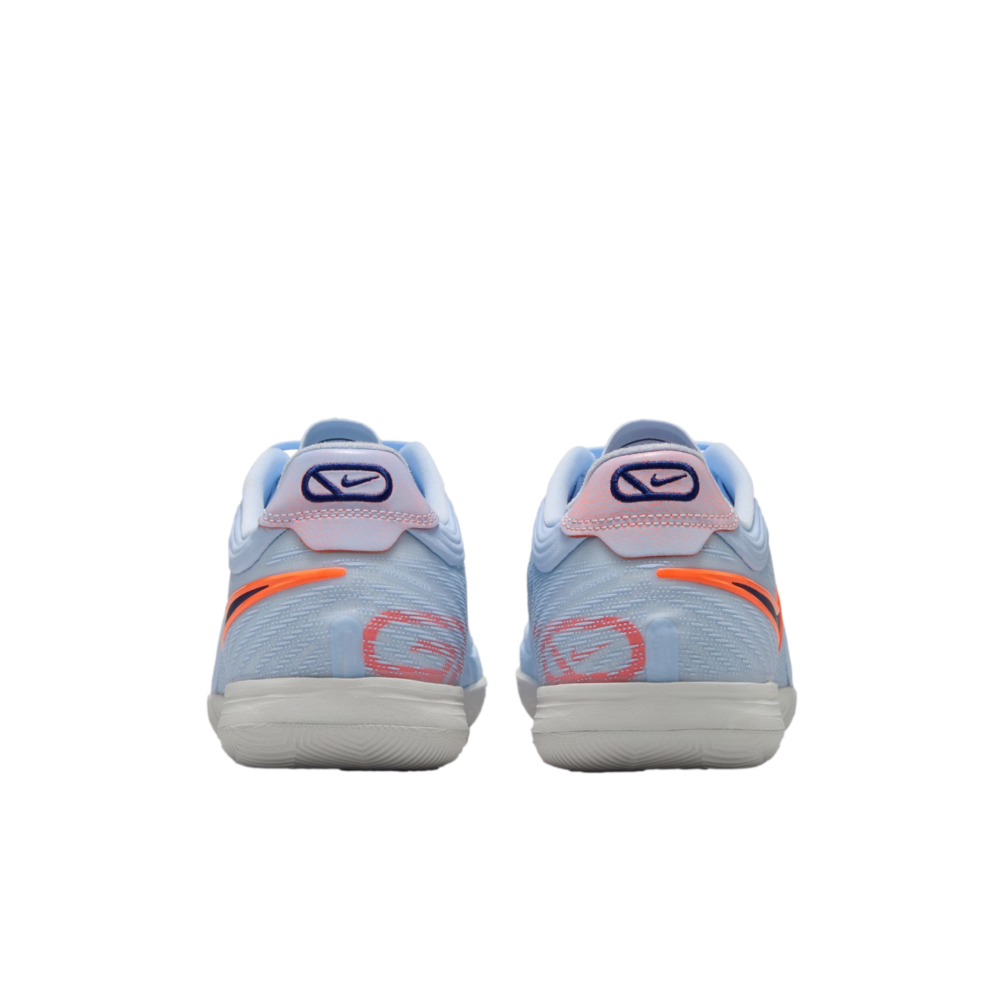 A rear view of a pair of light blue Nike performance sneakers featuring orange and coral accents, with a white textured sole, set against a solid black background.