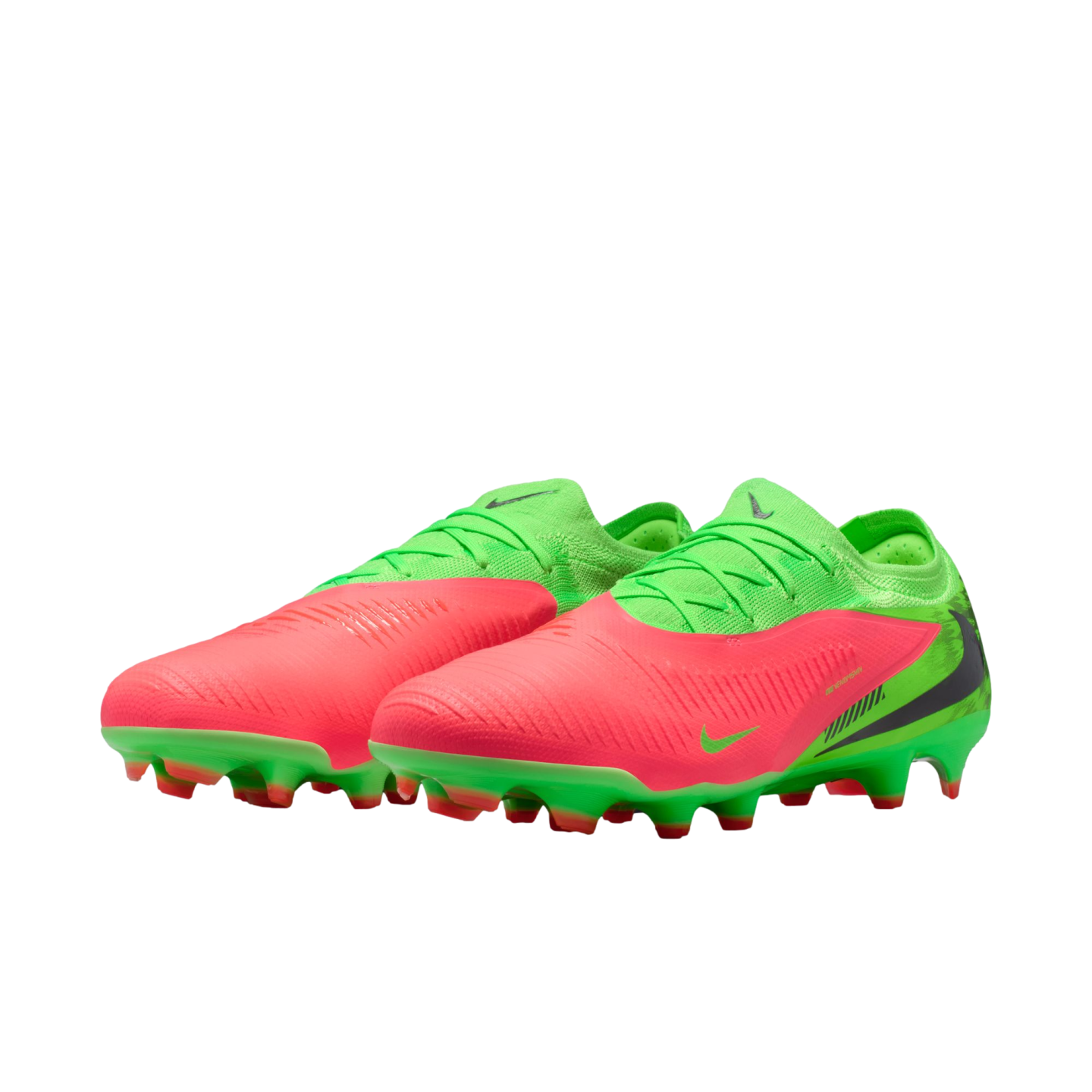 A pair of lime green and coral pink Nike soccer cleats with a textured upper and a studded green sole, set against a black background.