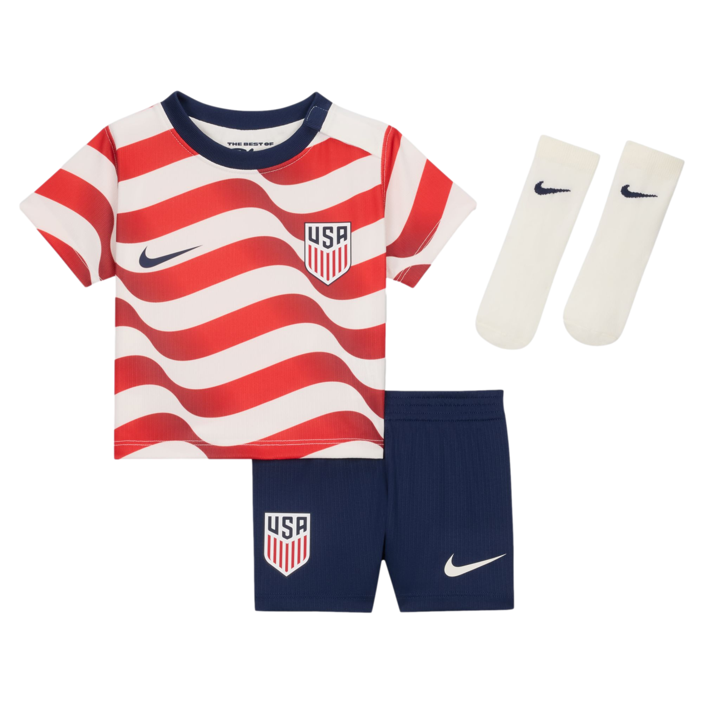 A kids' USA soccer kit featuring a red and white wavy-striped jersey, navy shorts, and white socks, all with Nike swooshes and USA crests.