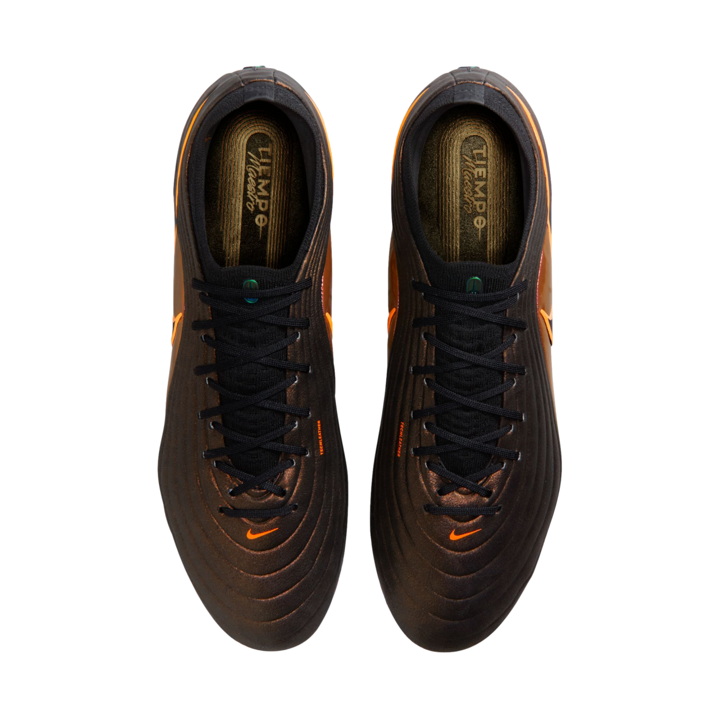 Top-down view of bronze Nike Tiempo Maestro soccer cleats with black laces and orange swoosh logos, set against a solid black background.