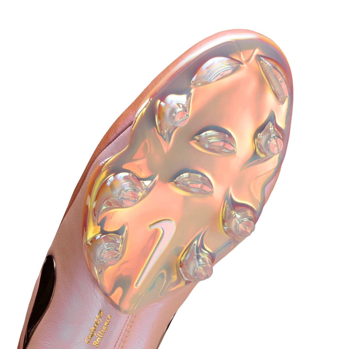 Underside of a pink Nike soccer cleat featuring a shimmering, iridescent soleplate with clear studs and "Crafted for Brilliance" embossed in gold text.