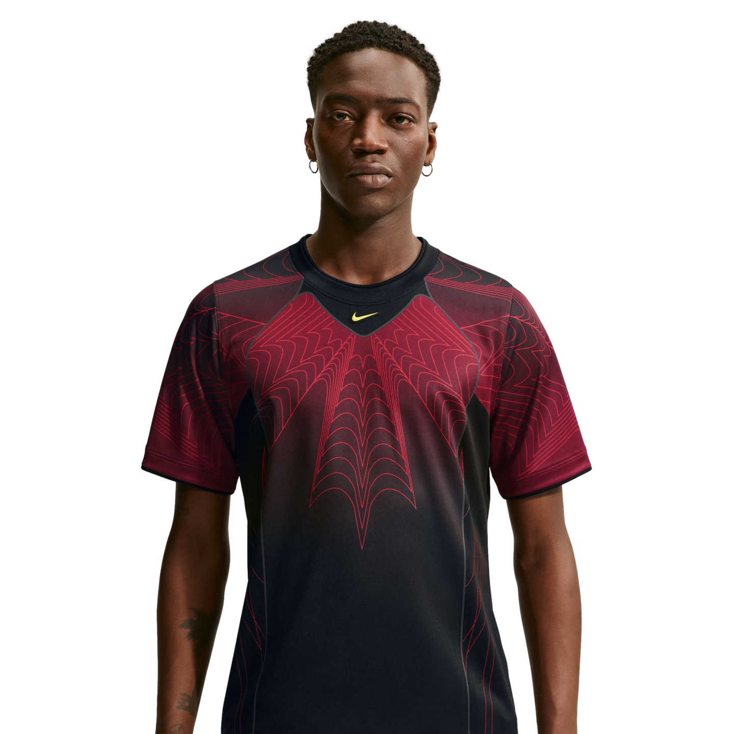 A man wearing a black Nike t-shirt with a large, red web-like graphic on the chest, facing forward against a white background.