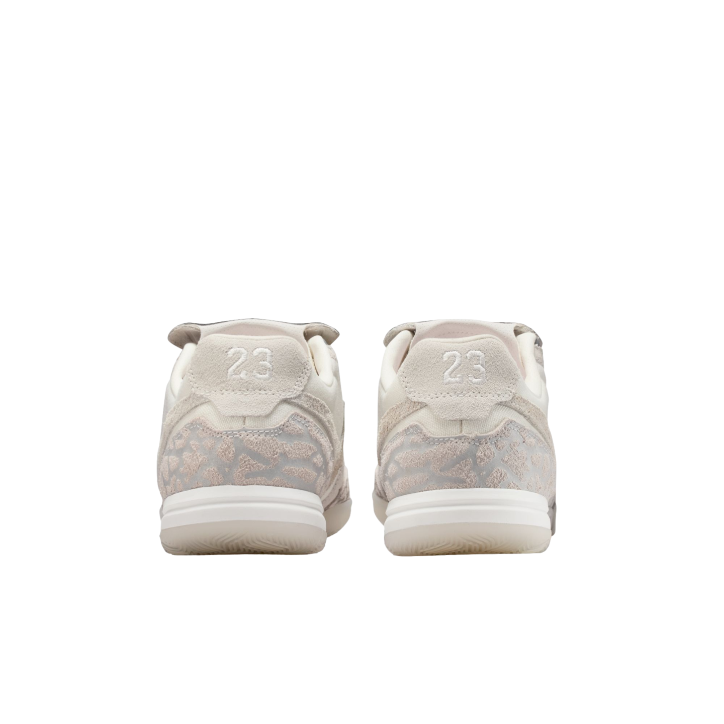 Rear view of a pair of light gray and white sneakers with the number "23" embroidered on the heels, set against a black background.