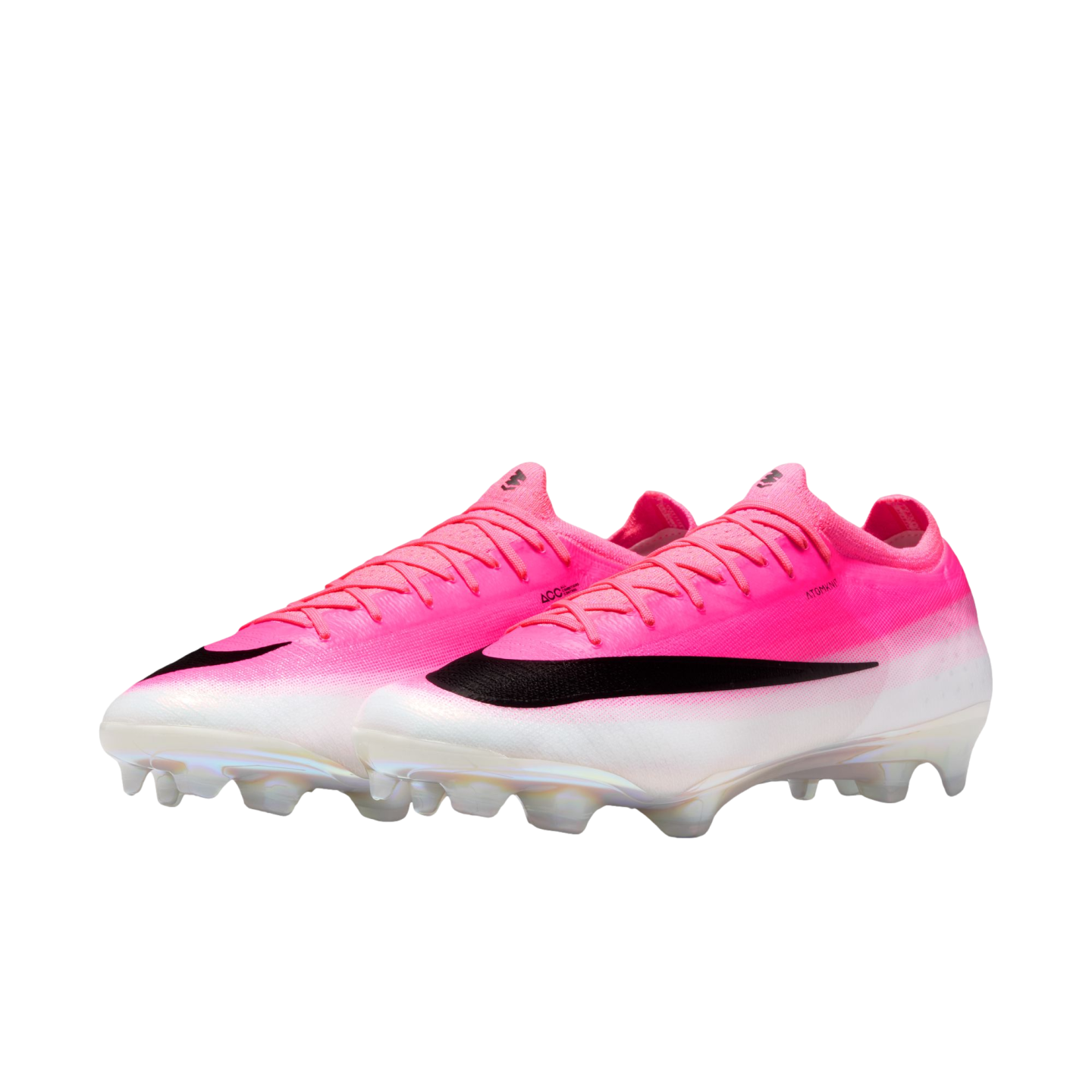 A pair of Nike soccer cleats featuring a pink-to-white gradient upper, a large black swoosh, and white studs, isolated on a white background.