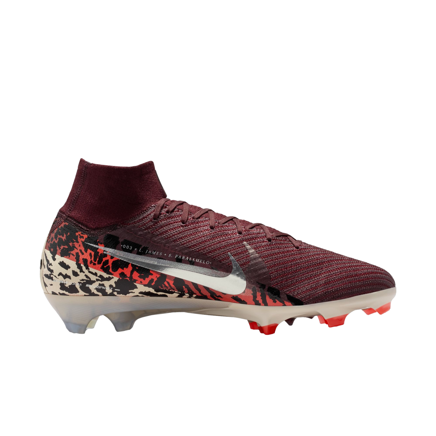 A side profile of a Nike Mercurial soccer cleat against a solid black background. The shoe features a textured burgundy knit upper with a high-top collar, a large metallic silver swoosh, and a heel wrapped in a bold black, red, and cream camouflage-like pattern. The sole is translucent cream with bright red studs.
