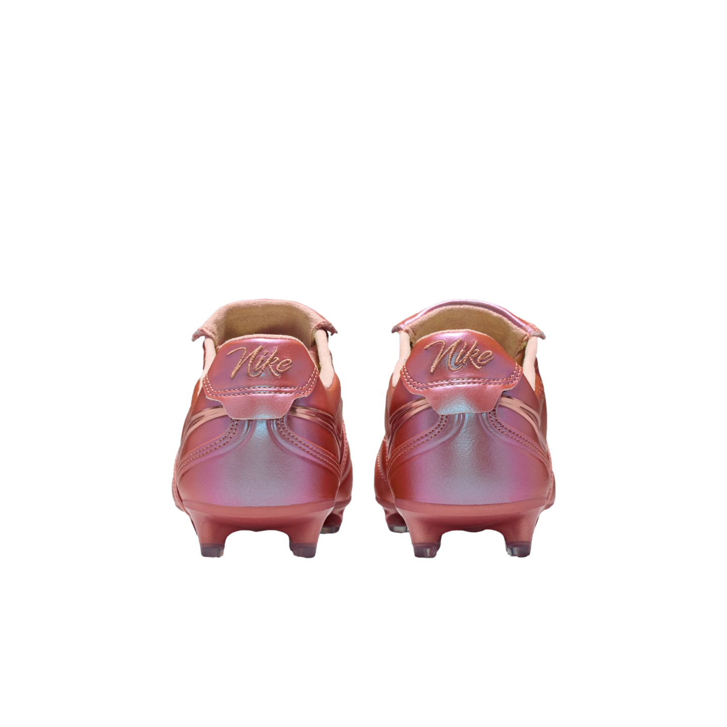 Rear view of two Nike soccer cleats in iridescent metallic rose gold with script logos on the heels, set against a black background.