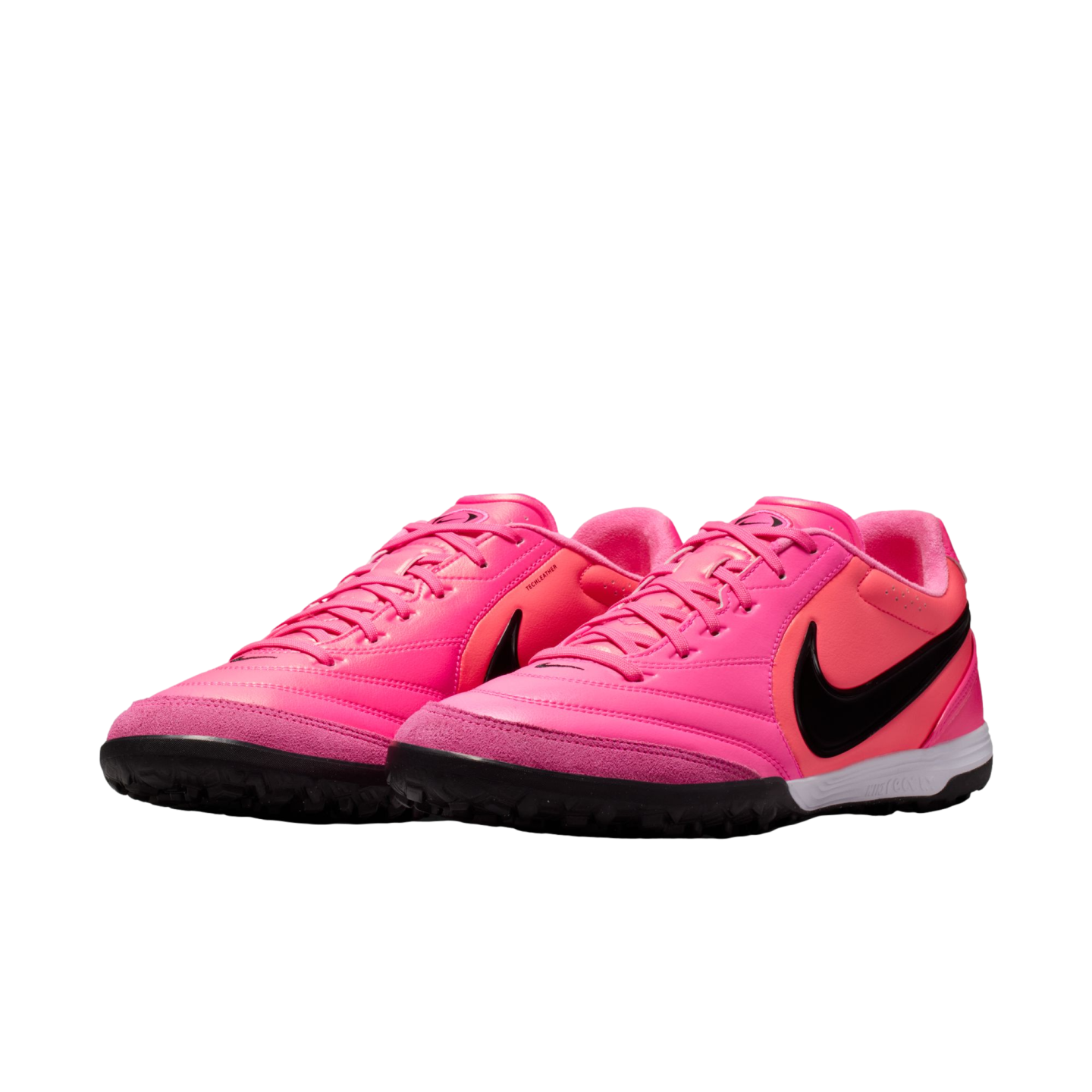 A pair of vibrant hot pink Nike turf soccer shoes with black swooshes and pink laces on a white background.