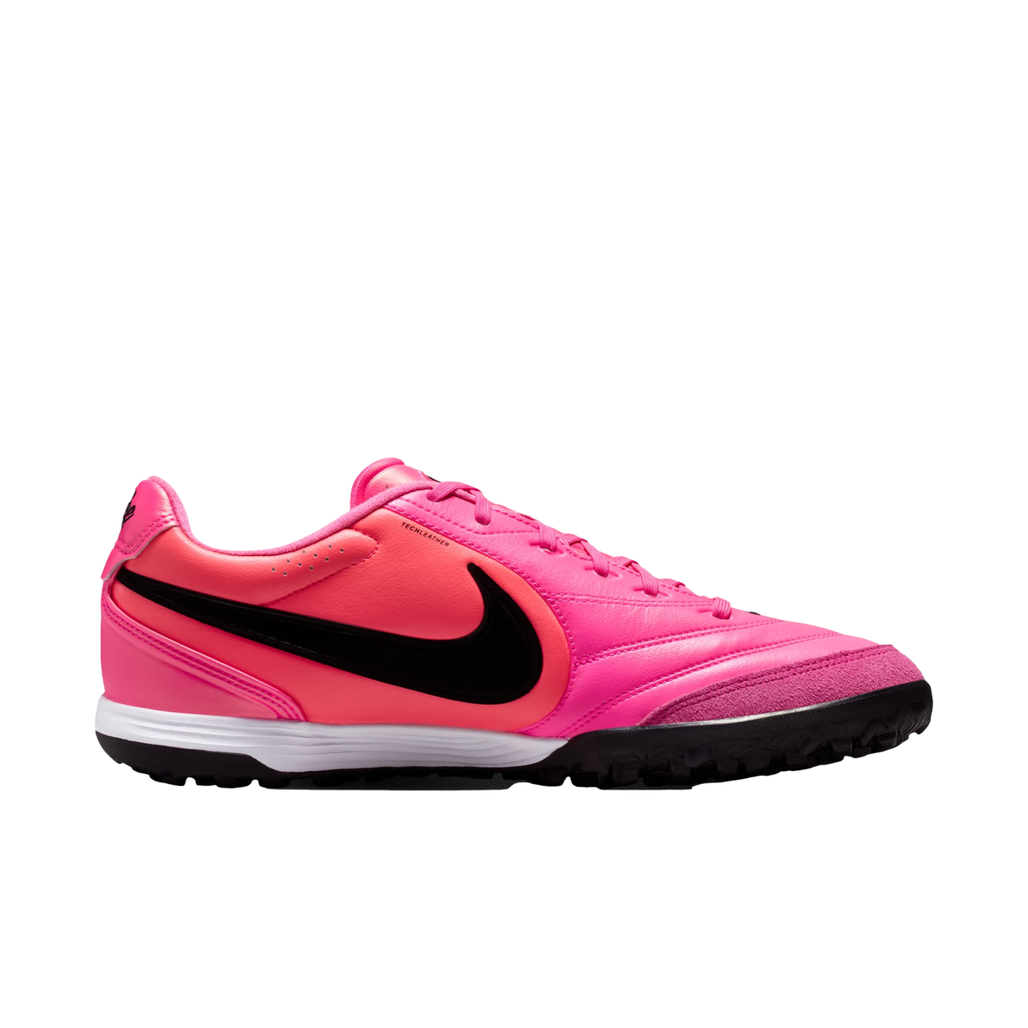 Side-profile of a vibrant pink Nike turf soccer shoe with a large black Swoosh, white midsole, and black textured outsole.