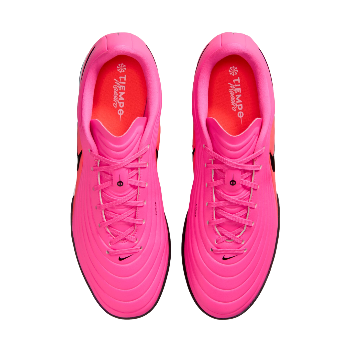 Top-down view of bright pink Nike Tiempo Maestro soccer cleats with orange insoles and black details on a white background.